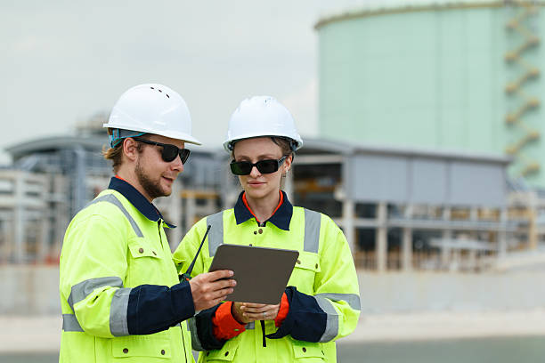 istock Engineers inspect oil refinery and storage tanks. 2248624862