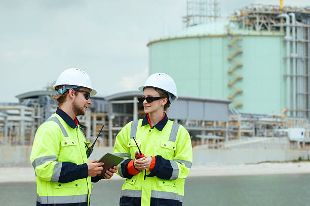 istock Engineers inspect oil refinery and storage tanks. 2248624875