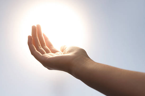 istock Young Woman's Open Hand Reaching Toward Sunlight - Hope and Connection 2248625801