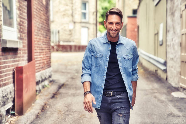 istock casual young man standing by a brick ball 2248625913