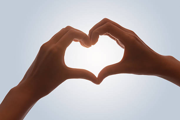 istock Hands Making Heart Shape Love Gesture Against Sky 2248625971