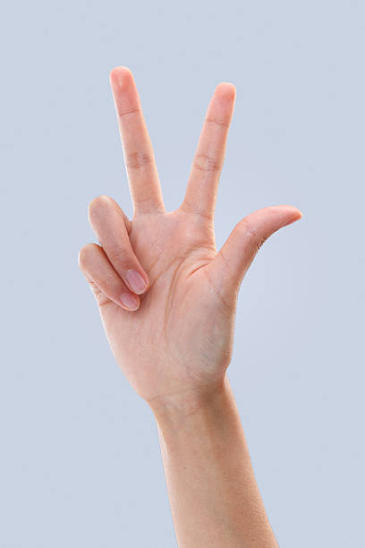 istock Young Man Hand Peace Victory Sign Gesture Gray Background 2248626070