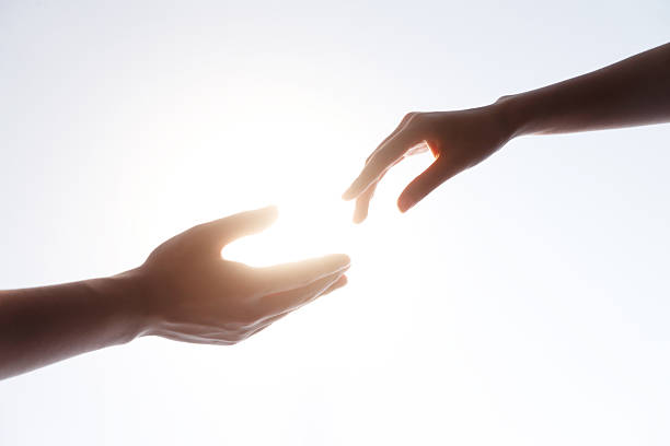 istock Hands Reaching Together in Sunlight - Friendship and Connection 2248626086