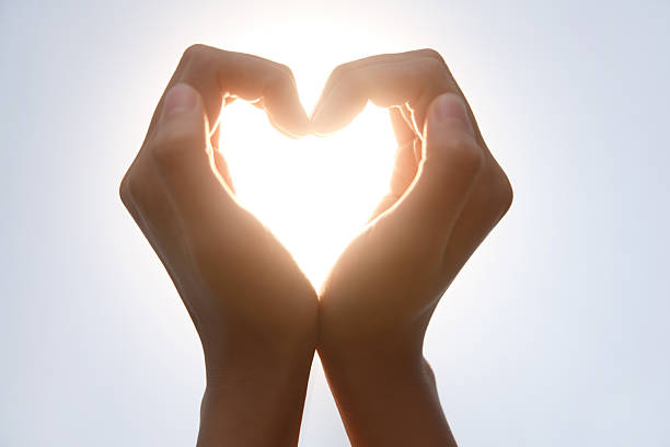 istock Hands Making Heart Shape in Sunlight - Love and Romance Gesture 2248626190