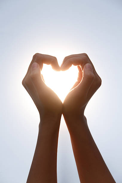 istock Hands Making Heart Shape in Sunlight - Love and Romance Gesture 2248626191