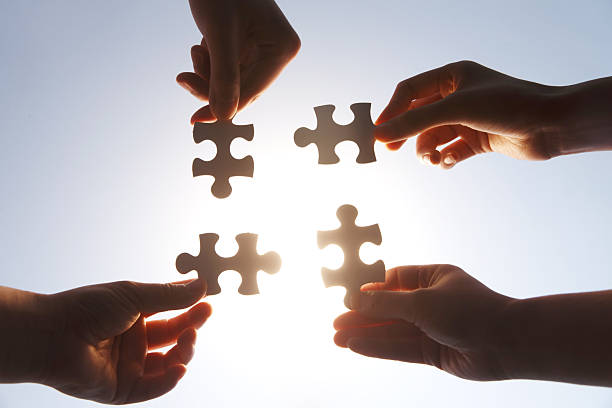 istock Hands Holding Jigsaw Puzzle Pieces - Teamwork and Collaboration 2248626279