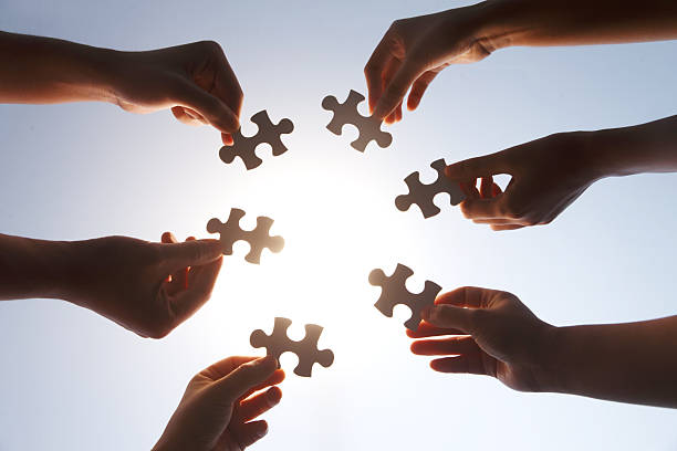istock Team Hands Holding Puzzle Pieces Together Collaboration 2248626285