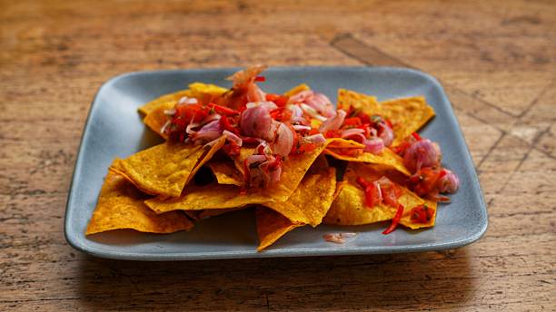 istock Crispy corn chips (nachos) served on a grey plate, generously topped with Balinese-style sambal matah, featuring sliced shallots, bird's eye chilies, and other fresh seasonings 2248626304