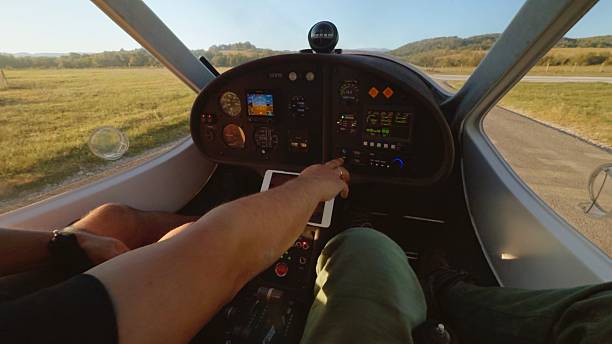 Point of view shot of pilot with a friend preparing a small airplane for morning flight over the mountains in Europe at sunrise. Luxury hobbies and high society