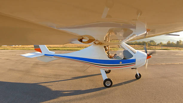 istock Senior Friends In Personal Plane Rolling On Runway. Flying At Sunrise 2248626799