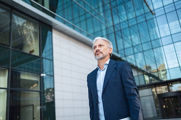 istock Mature businessman looking ahead in modern city 2248626975