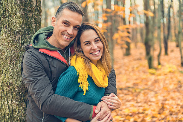 istock happy autumn fall couple in a park 2248627388
