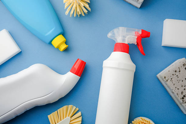 istock Household cleaning supplies and brushes arranged on a blue surface, ready for use. 2248627699