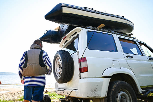 istock Man preparing inflatable boat for beach adventure 2248630174