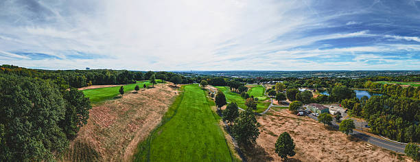 istock Expansive view of a lush golf course framed by vibrant trees and serene landscapes during a sunny day 2248630654
