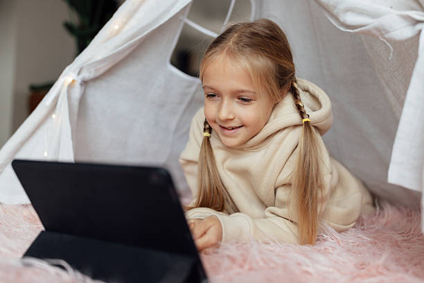 istock Caucasian kid studying online at home and using tablet. Distance or remote learning for child. Pretty stylish schoolgirl studying homework during coronavirus covid-19 quarantine and social distancing 2248639796