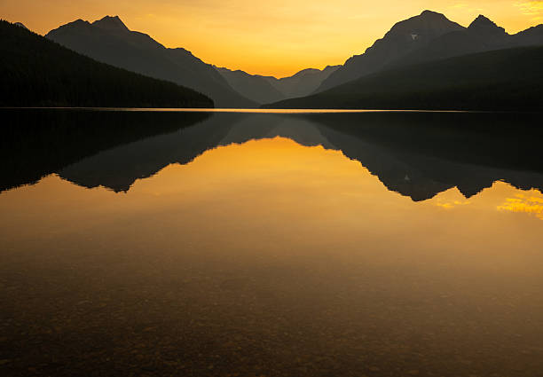 Orange Light Lingers Over Reflection in Bowman Lake in Glacier