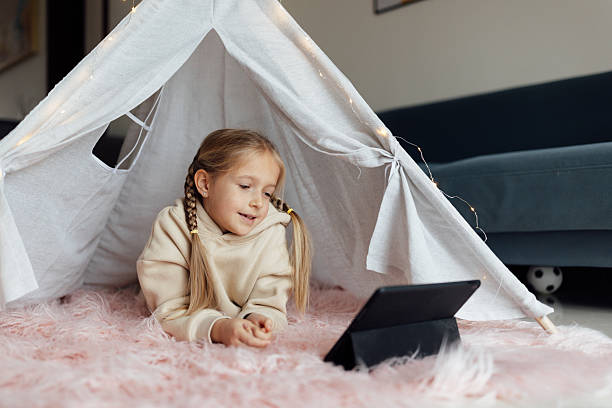 istock Caucasian kid studying online at home and using tablet. Distance or remote learning for child. Pretty stylish schoolgirl studying homework during coronavirus covid-19 quarantine and social distancing 2248640346