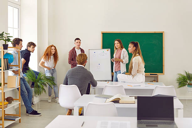 istock Happy school, college or university students having creative lesson with their teacher 2248640922