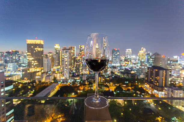 istock Effervescent city night: A wine flute against a luminous urban backdrop 2248645639