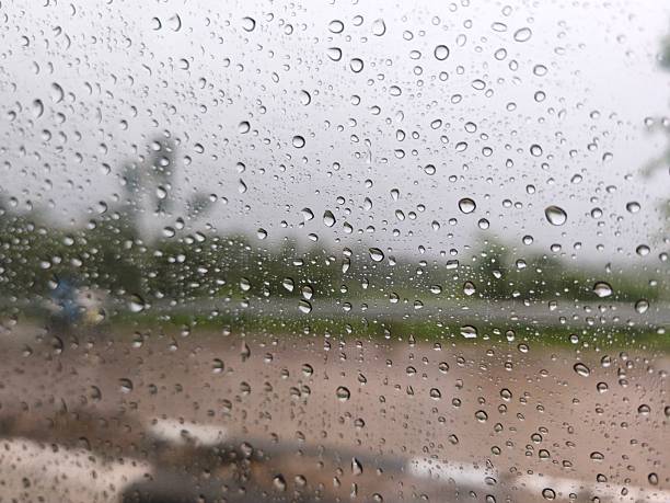 Raindrops on a car window that are not visible from the front.