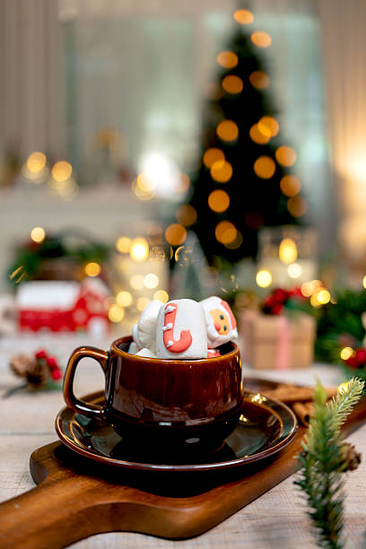 Hot chocolate with Christmas decoration on wooden table background. Marshmallow Shooter Drink Recipe on winter season.