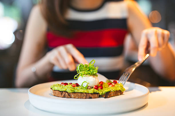 Woman eating breakfast guacamole avocado healthy food menu at restaurant