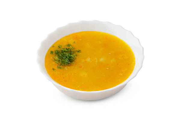 istock Yellow lentil soup topped with fresh herbs in a white bowl 2248655653