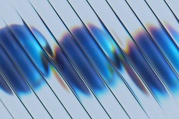 A close-up abstract image featuring glass strips arranged diagonally and blue round shapes behind it. Light creates rainbow reflections and glossy highlights, suggesting modern design, technology, and futuristic aesthetics.