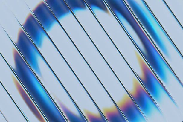 A close-up abstract image featuring glass strips arranged diagonally and defocused blue ring behind it. Light creates rainbow reflections and glossy highlights, suggesting modern design, technology, and futuristic aesthetics.