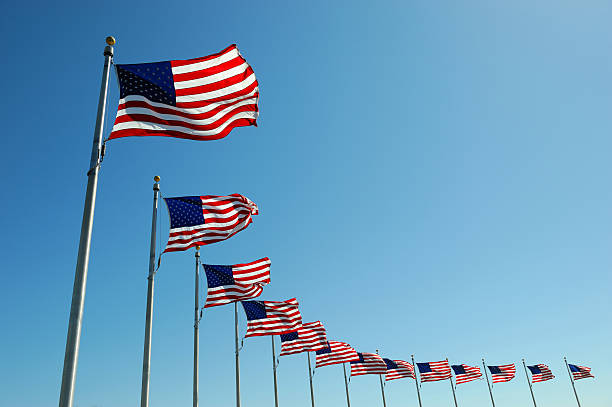 istock USA flags in a row waving in the wind 2248659318