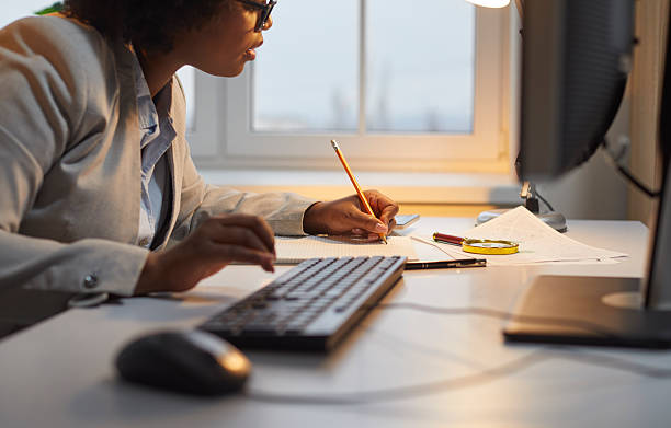 istock Woman auditor checking financial documents over office desk with magnifying glass 2248659543