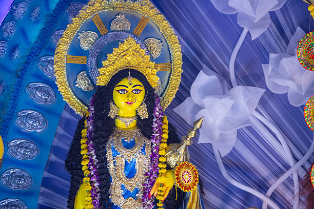 A beautifully crafted handmade colorful goddess durga idol decorated for Navratri, featuring vibrant traditional attire, intricate jewellery, and divine expressions at colorful pandal.