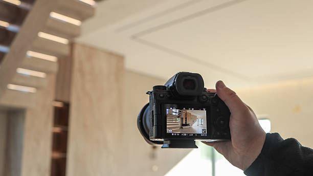 istock Photographer capturing a modern interior with a staircase and natural light 2248660720