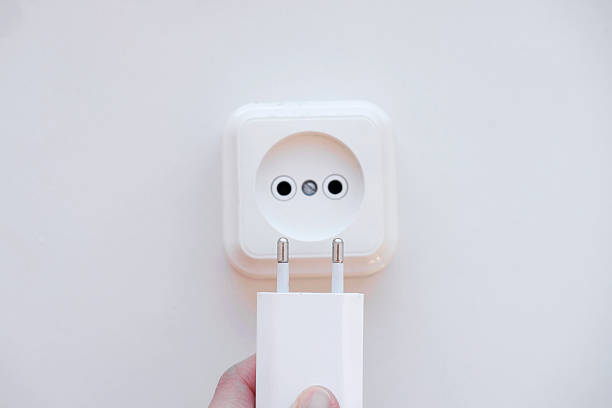 istock Close-up of the white electrical power socket and plug socket on wall, table 2248663894