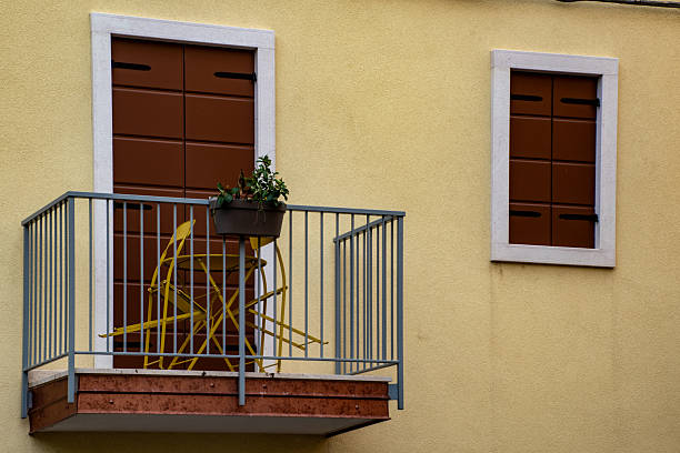Pastel yellow orange green blue colorful architecture exterior of condo apartment building hotel resort in Florida beach home, pattern, many balconies