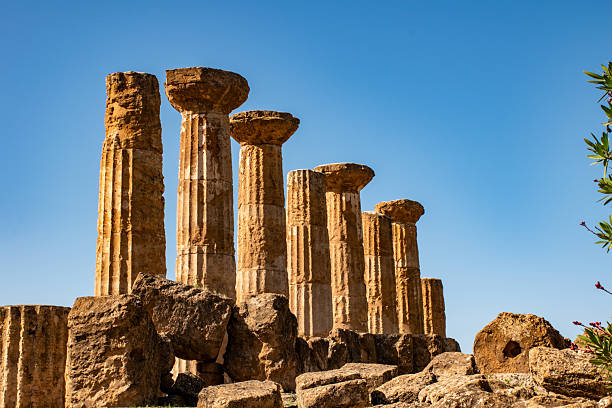 This captivating image showcases the ruins of Valle dei Templi, an extraordinary archaeological site located in Sicily, Italy. Renowned for its well-preserved ancient Greek temples, this UNESCO World Heritage site offers a glimpse into the grandeur of the ancient world. The impressive ruins, set against a backdrop of rolling hills and olive groves, highlight the architectural brilliance and historical significance of the ancient Greek civilization in Sicily. Visitors can explore the site to witness the majestic columns and intricate details that have stood the test of time. This photograph is perfect for travel, history, or cultural projects, capturing the essence of Sicily's rich heritage and the beauty of its ancient landmarks. It serves as an invitation to explore the fascinating history and breathtaking scenery of Valle dei Templi, making it an excellent choice for those looking to showcase the allure of this remarkable destination.