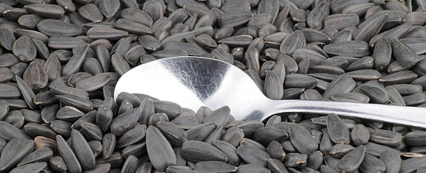 sunflower seeds background and one teaspoon