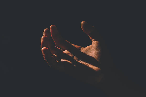istock A human hand illuminated by sunlight amidst darkness. The high contrast between light and shadow creates a dramatic and artistic atmosphere. The concept of hope, the search for light, and life 2248665489