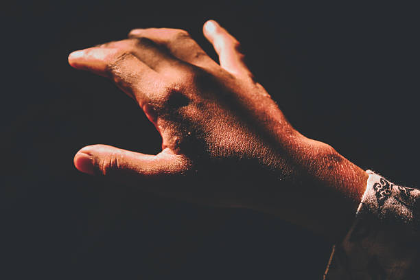 istock A human hand illuminated by sunlight amidst darkness. The high contrast between light and shadow creates a dramatic and artistic atmosphere. The concept of hope, the search for light, and life 2248665492