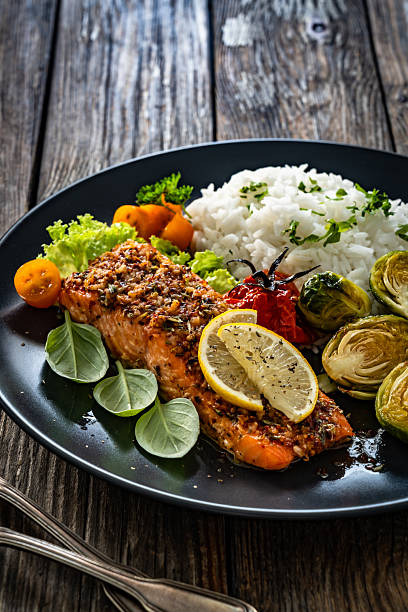 istock Baked salmon with white rice on wooden table 2248666922