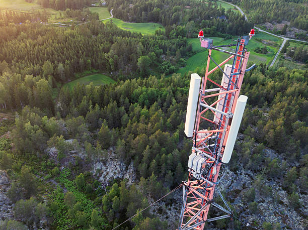 istock Mast with cellular network antennas in a forest landscape 2248667619