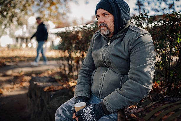 istock Homeless man experiencing poverty and despair in park 2248668703