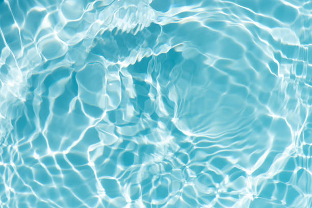 istock Blue water with ripples on the surface. Defocus blurred transparent blue colored clear calm water surface texture with splashes and bubbles. Water waves with shining pattern texture background. 2248668976