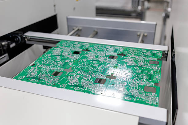 istock Green printed circuit board on automated electronics production line in factory 2248669883