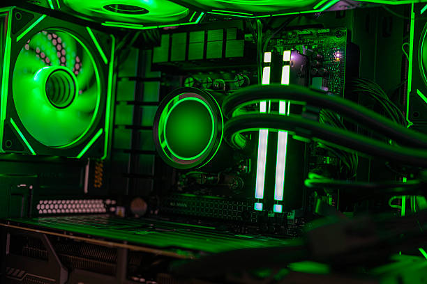 Close-up view of an advanced gaming computer interior featuring RGB-lit fans, liquid cooling tubes, illuminated RAM modules, and a futuristic neon color scheme for a high-performance setup
