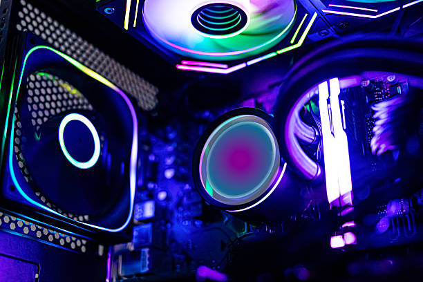 Close-up view of an advanced gaming computer interior featuring RGB-lit fans, liquid cooling tubes, illuminated RAM modules, and a futuristic neon color scheme for a high-performance setup