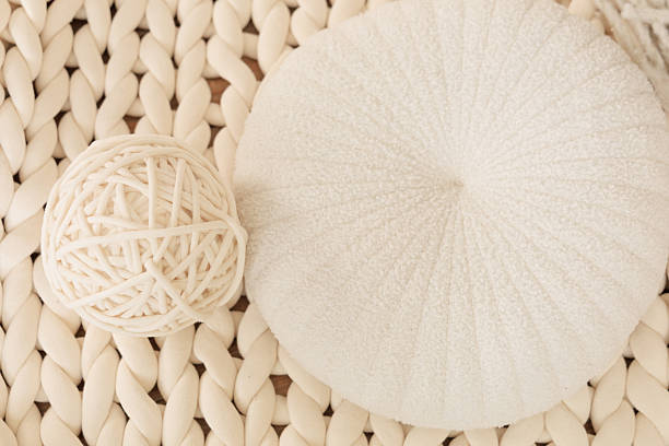 istock Decorative white ottoman and ball of thread on textured background for home interior design ideas 2248672833