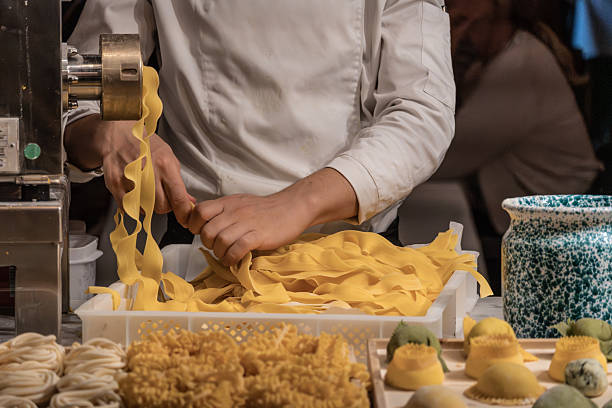 istock Chef making fresh italian pasta with tagliatelle machine in kitchen 2248673688
