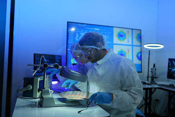 istock International male and female technicians wearing sterile suits work at a semiconductor manufacturing plant using microscopy 2248675585